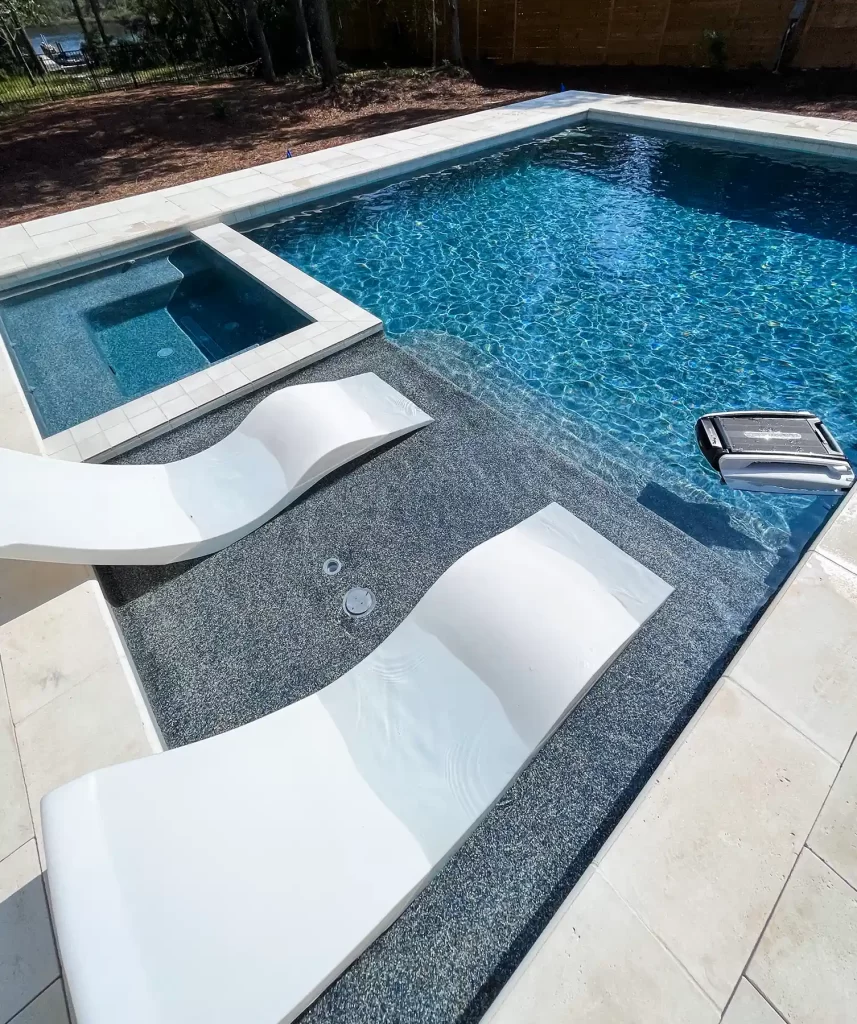 A photo of a custom pool with ledges and spa built by custom pool builder Emerald Coast Pools